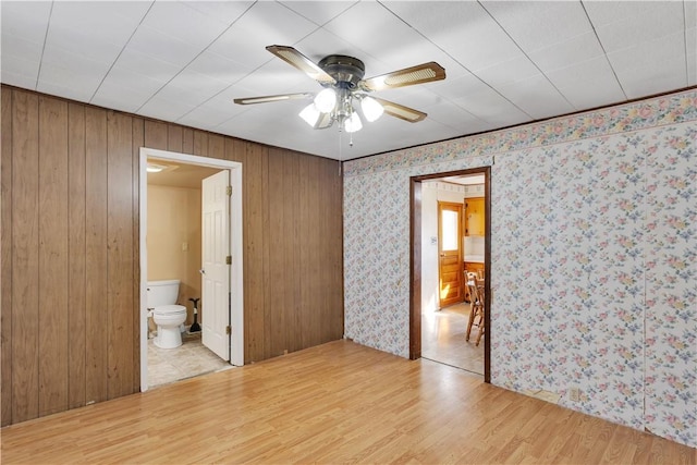 empty room with ceiling fan and light wood-style floors