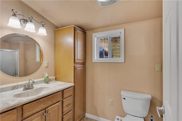 bathroom with toilet, visible vents, and vanity