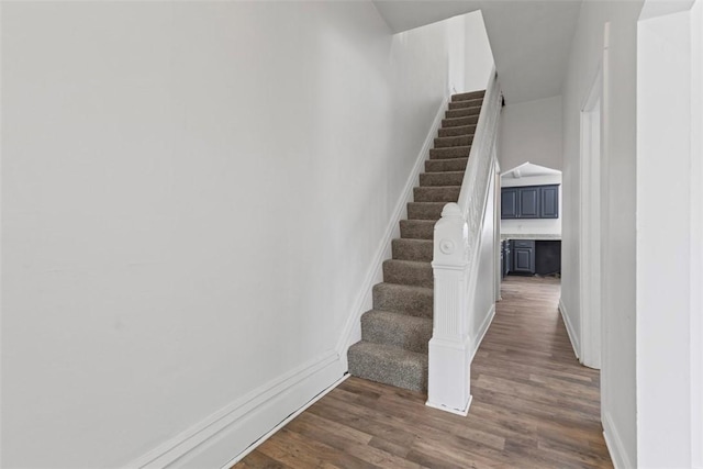 stairs featuring baseboards and wood finished floors