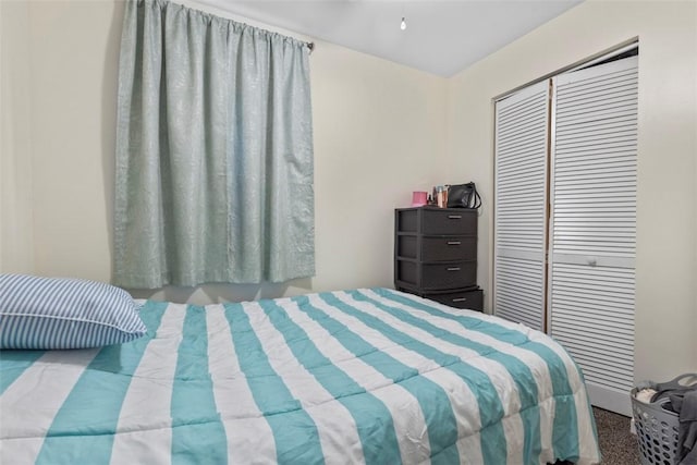 bedroom with a closet and light carpet