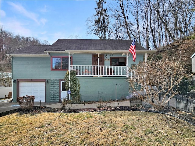 view of front of home featuring an attached garage, fence, a front lawn, and a porch