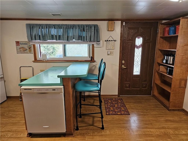 interior space with baseboards and wood finished floors