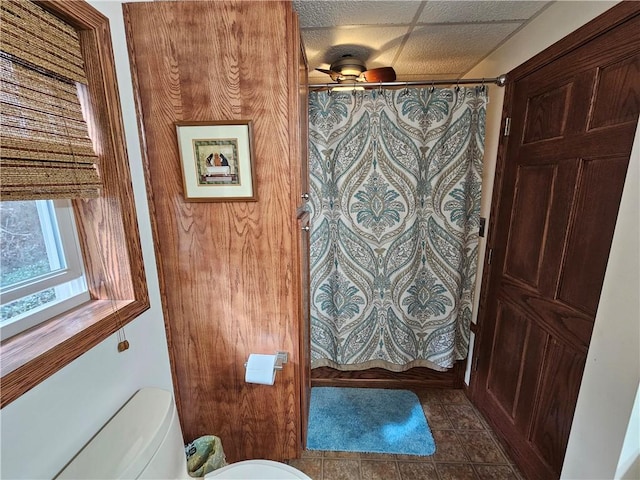 bathroom featuring toilet, tile patterned flooring, ceiling fan, and a drop ceiling