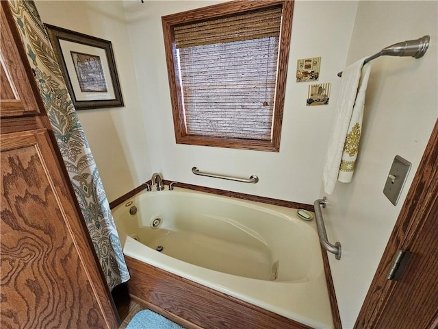 bathroom featuring a tub with jets