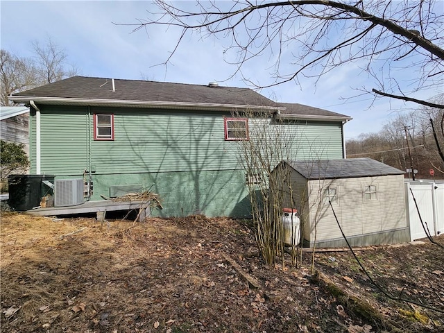 rear view of property with cooling unit