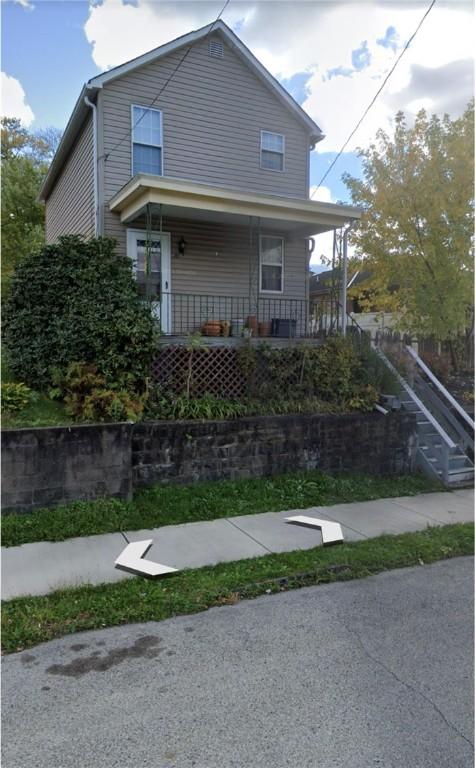 view of front of property featuring a porch and stairway