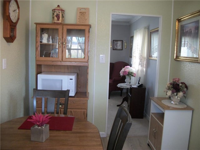 dining space featuring crown molding