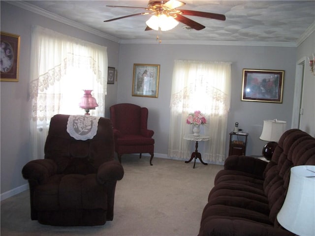 living room featuring baseboards, a ceiling fan, crown molding, and light colored carpet