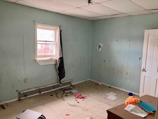 unfurnished room featuring a paneled ceiling