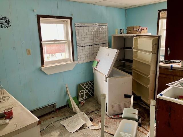 misc room with a paneled ceiling and baseboard heating