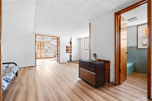 corridor with visible vents and light wood-style floors