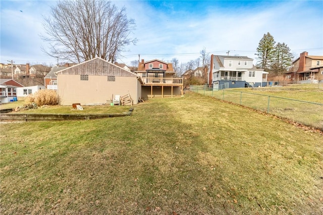 view of yard featuring a residential view, fence, and a deck