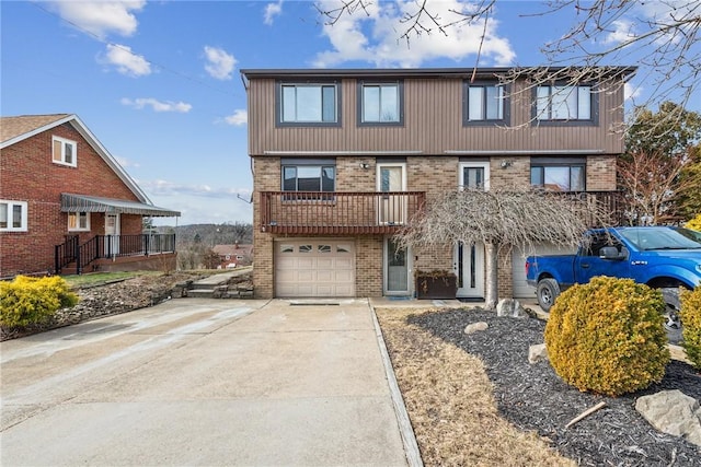 view of front of property featuring a garage, concrete driveway, and brick siding