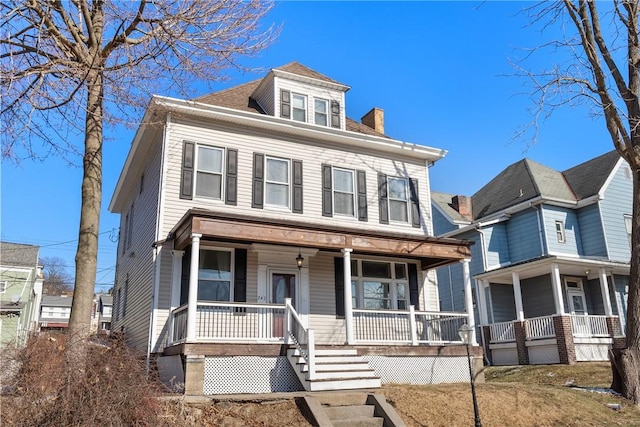 traditional style home with a chimney and a porch