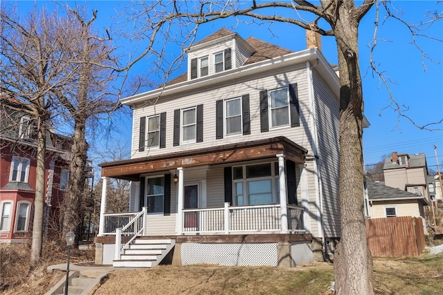 traditional style home with covered porch and a chimney