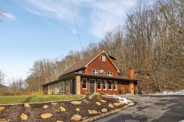 view of front of property with driveway and a chimney