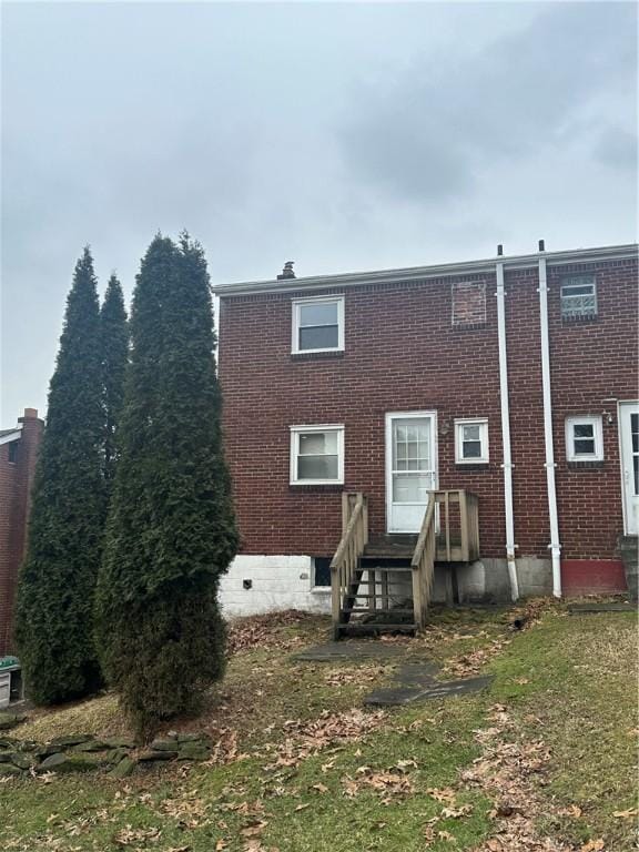 back of property featuring brick siding