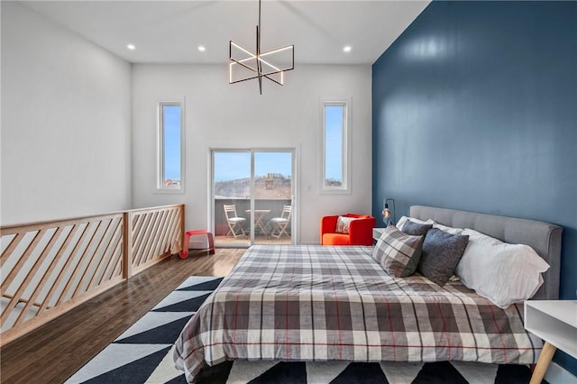 bedroom featuring recessed lighting, a notable chandelier, and wood finished floors