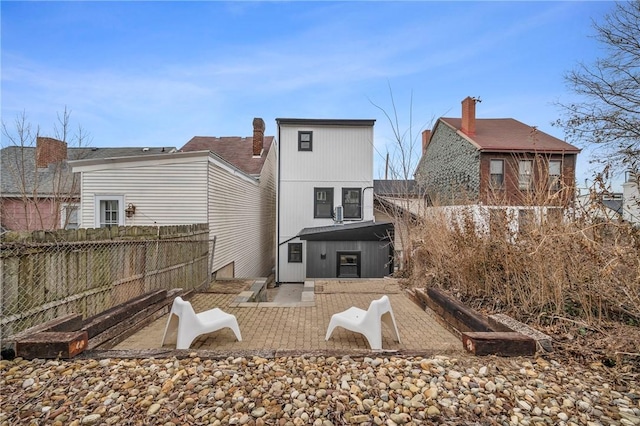 back of house with a patio and fence