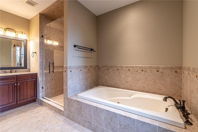 bathroom with tile patterned flooring, vanity, visible vents, a jetted tub, and a shower stall