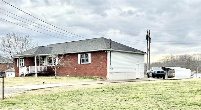 view of side of property featuring a lawn and brick siding