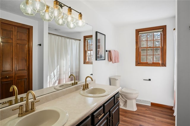 full bathroom featuring visible vents, a sink, and wood finished floors