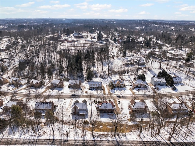 snowy aerial view with a residential view