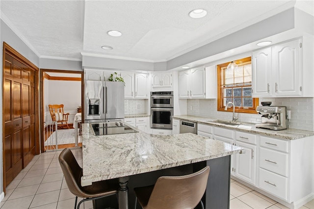 kitchen with stainless steel appliances, white cabinets, and a sink