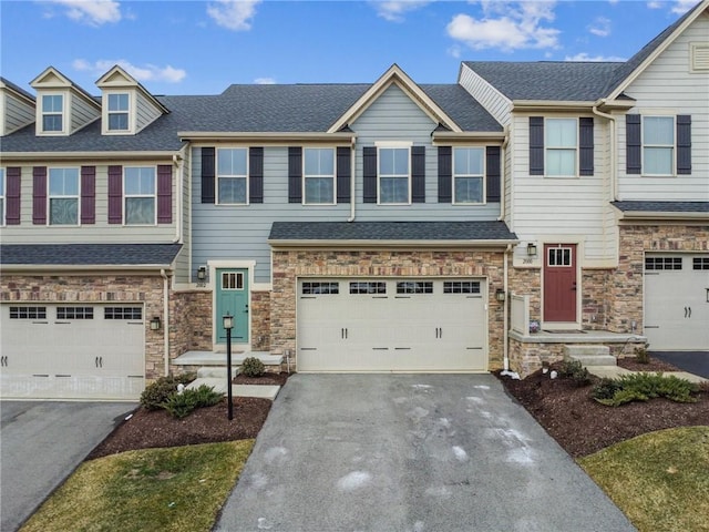 2002 Callaway Dr, Jeannette, PA 15644 - townhome / multi-family property with driveway, stone siding, a garage, and roof with shingles