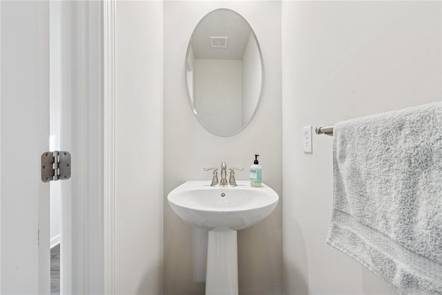 bathroom featuring visible vents and a sink