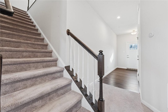 stairs with recessed lighting, carpet flooring, baseboards, and wood finished floors