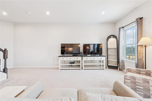 living room with recessed lighting, baseboards, and light colored carpet