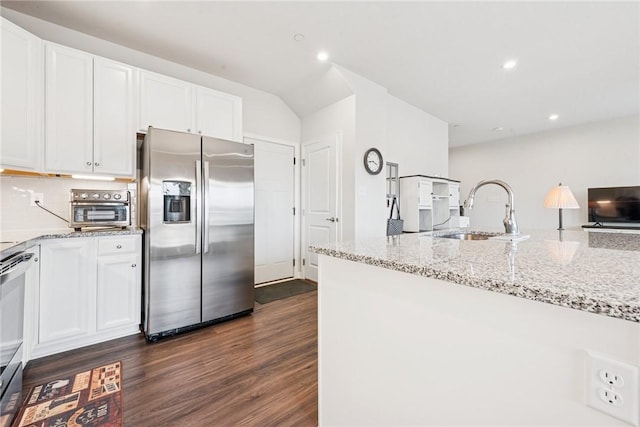 kitchen with stainless steel appliances, dark wood-type flooring, a sink, white cabinetry, and light stone countertops