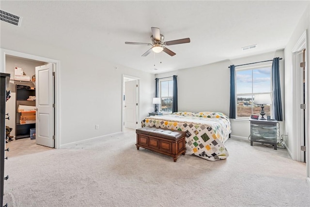 bedroom featuring multiple windows, visible vents, and light colored carpet