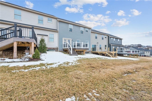 back of house with a wooden deck, a residential view, and a yard