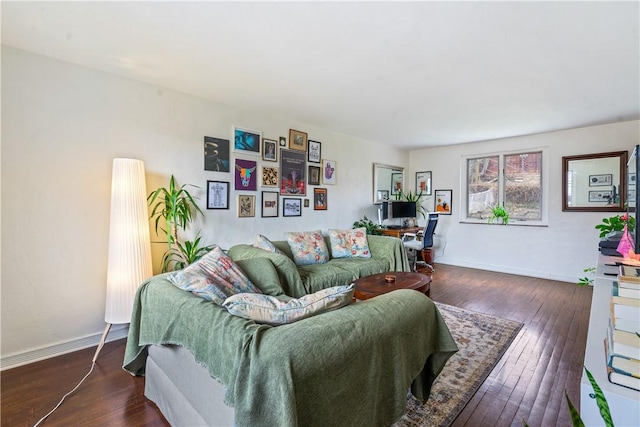 living room featuring baseboards and dark wood finished floors