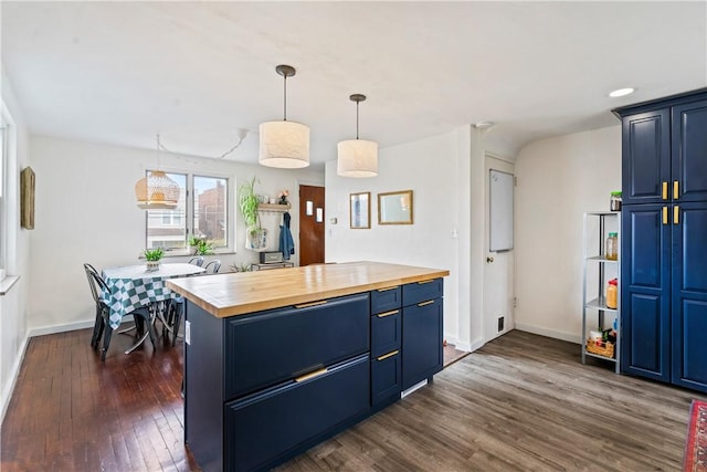 kitchen with a center island, dark wood-style flooring, decorative light fixtures, wooden counters, and blue cabinets