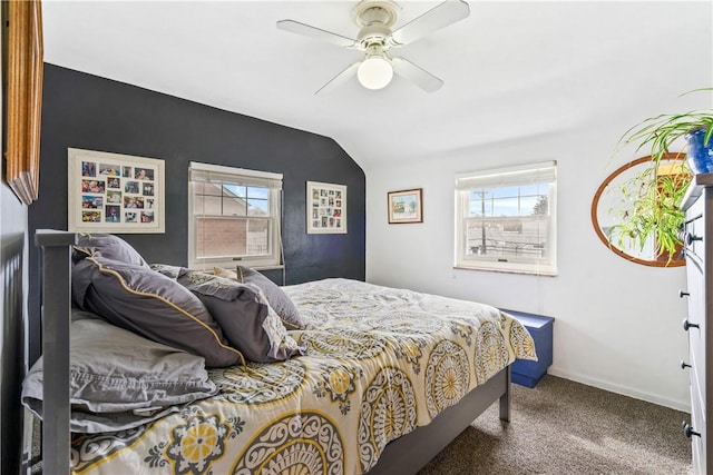 carpeted bedroom featuring lofted ceiling, ceiling fan, multiple windows, and baseboards