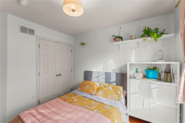 bedroom featuring visible vents and a closet