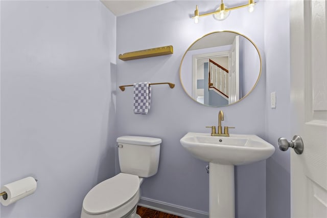 half bath with toilet and baseboards