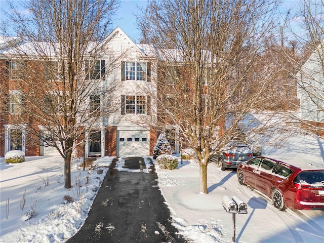 view of front of property with aphalt driveway and brick siding