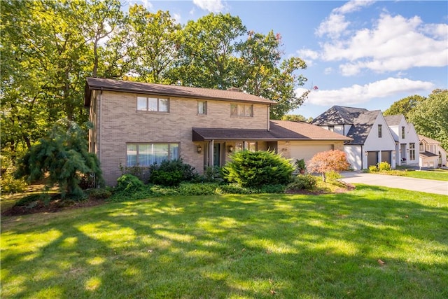 traditional-style home featuring a garage, brick siding, driveway, and a front lawn