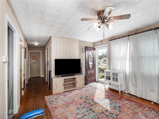 living room with a ceiling fan and dark wood-style flooring