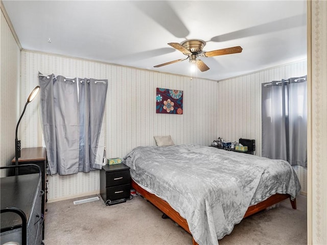 bedroom featuring baseboards, carpet floors, a ceiling fan, and wallpapered walls