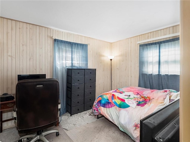 bedroom featuring wood walls