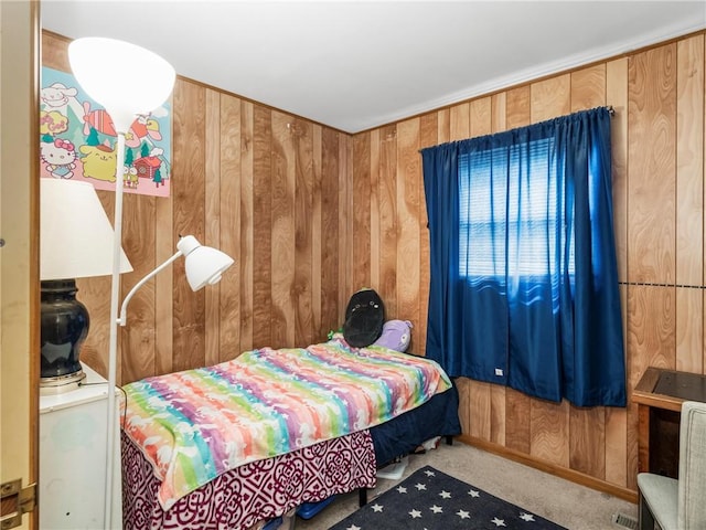 carpeted bedroom with wooden walls