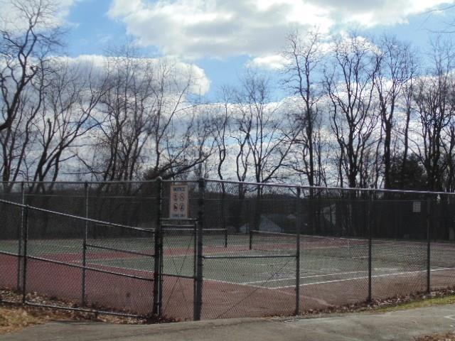 view of tennis court featuring fence