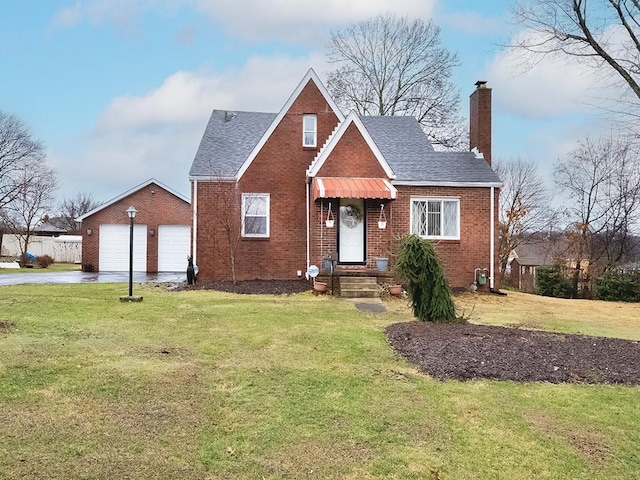 view of front facade with driveway, a shingled roof, a chimney, a front lawn, and brick siding