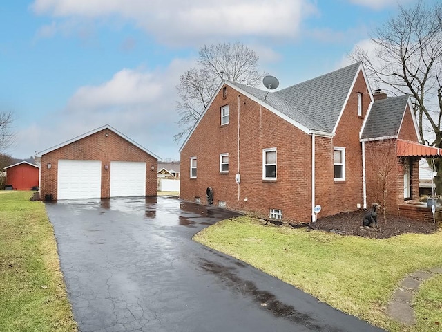 view of property exterior with brick siding, a shingled roof, a detached garage, and a yard