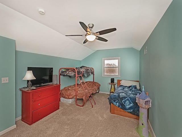 bedroom with light carpet, vaulted ceiling, baseboards, and ceiling fan